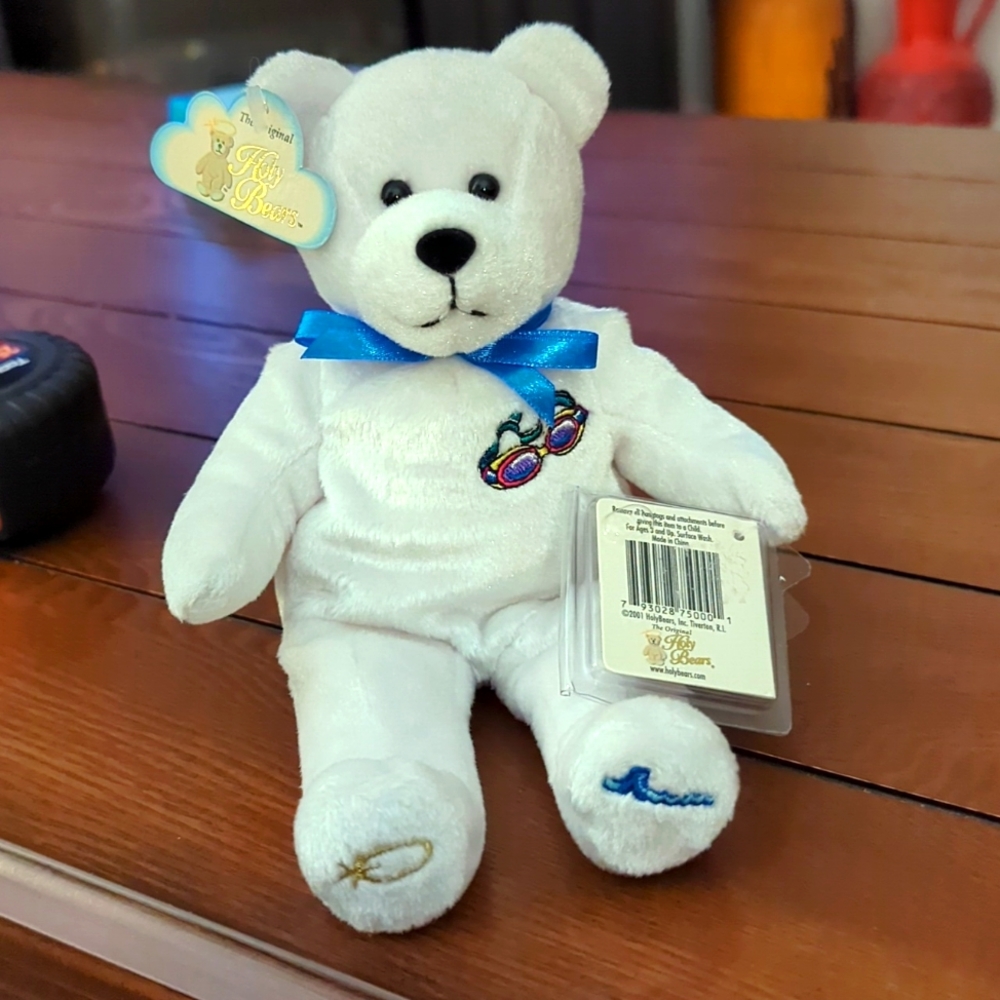 - Holy Bears . White bear with swimming goggles on chest .